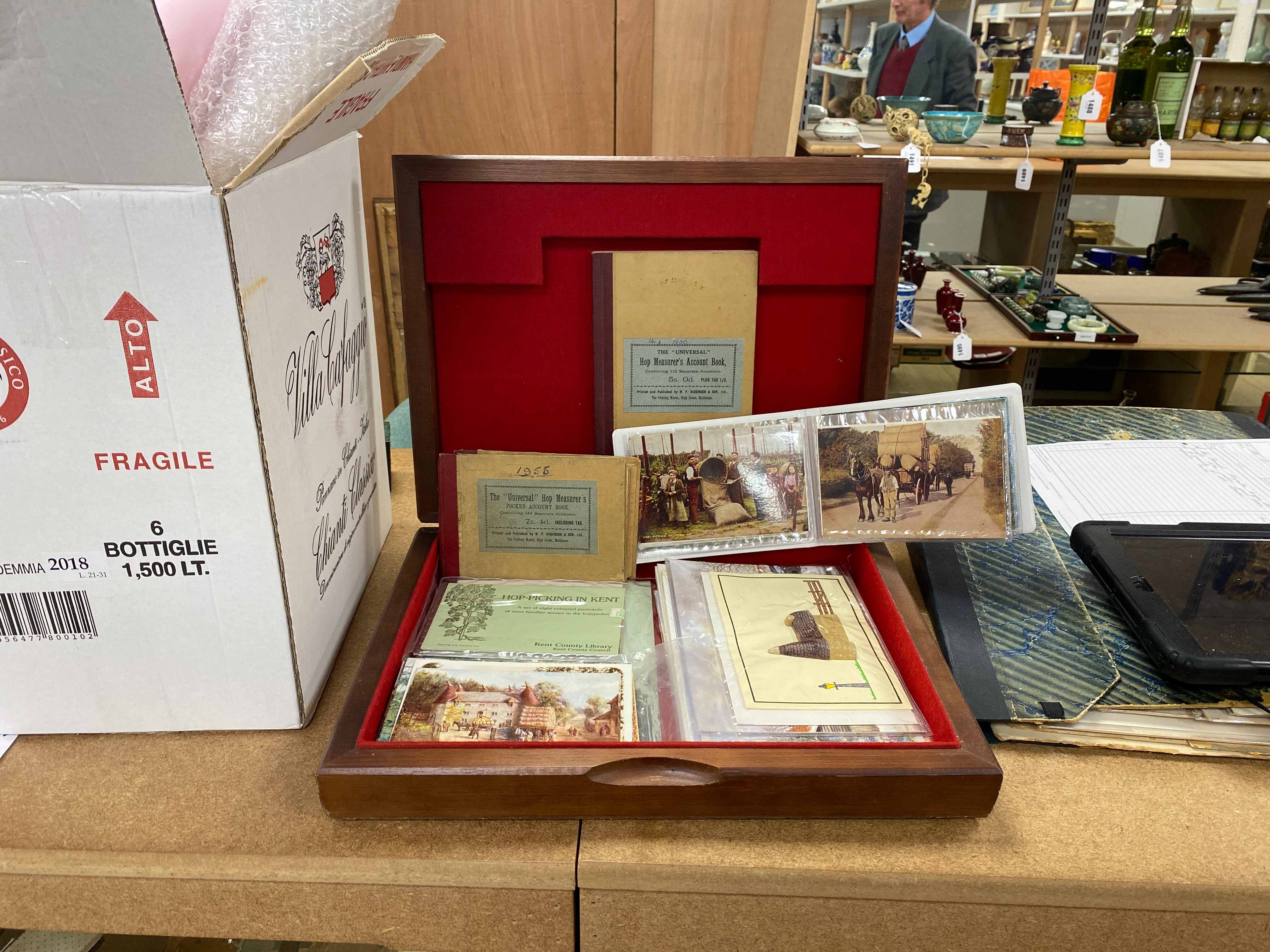 A collection of hop-related material: tokens, Whitbread advertising, framed print, pot lid type comport, postcards, book